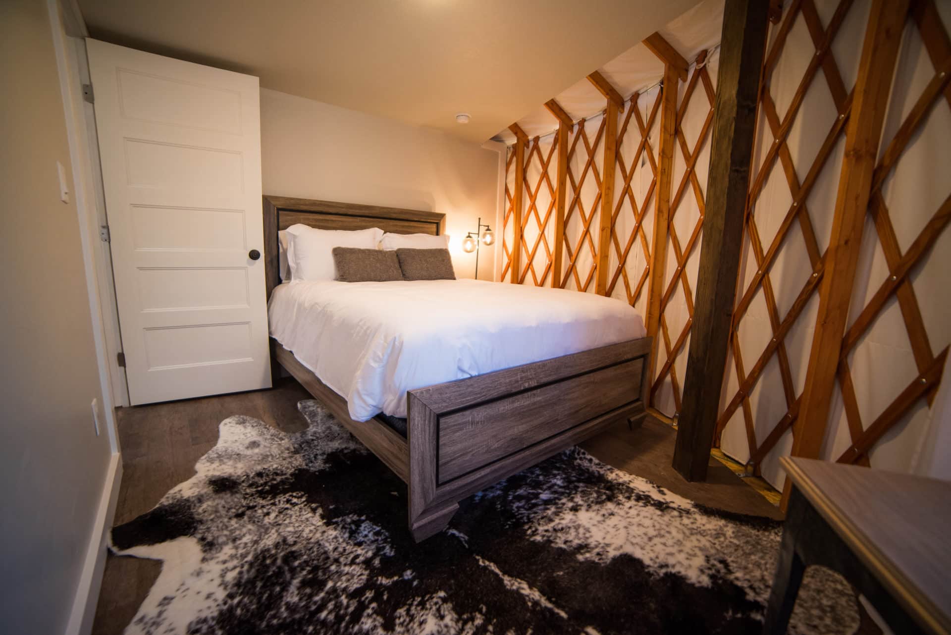 Cozy yurt bedroom nook with natural wood walls and soft lighting