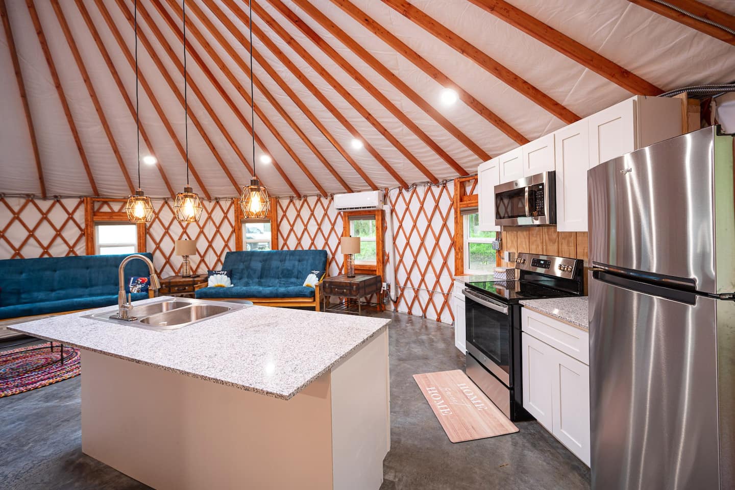 Gourmet kitchen inside a Colorado Yurt featuring center island and stainless steel appliances